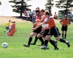 Soccer Players competing for ball.