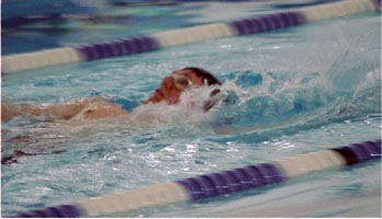 Athlete swimming backstroke